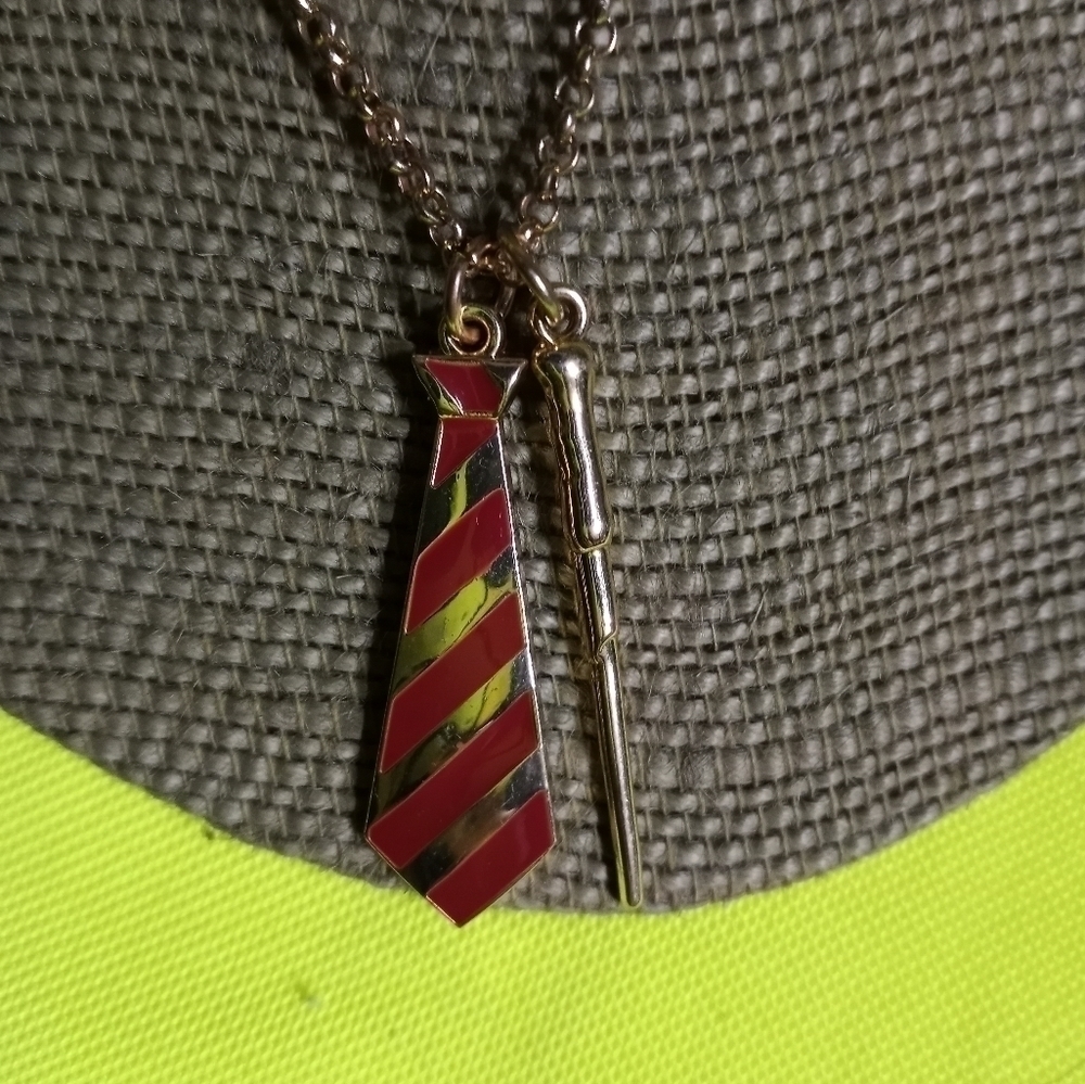 Goldtone red tie wand jcm necklace